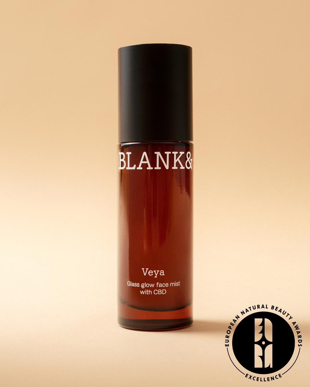 Blank & Veya glass glow face mist with CBD on a beige background and with European Natural Beauty Awards Excellence logo